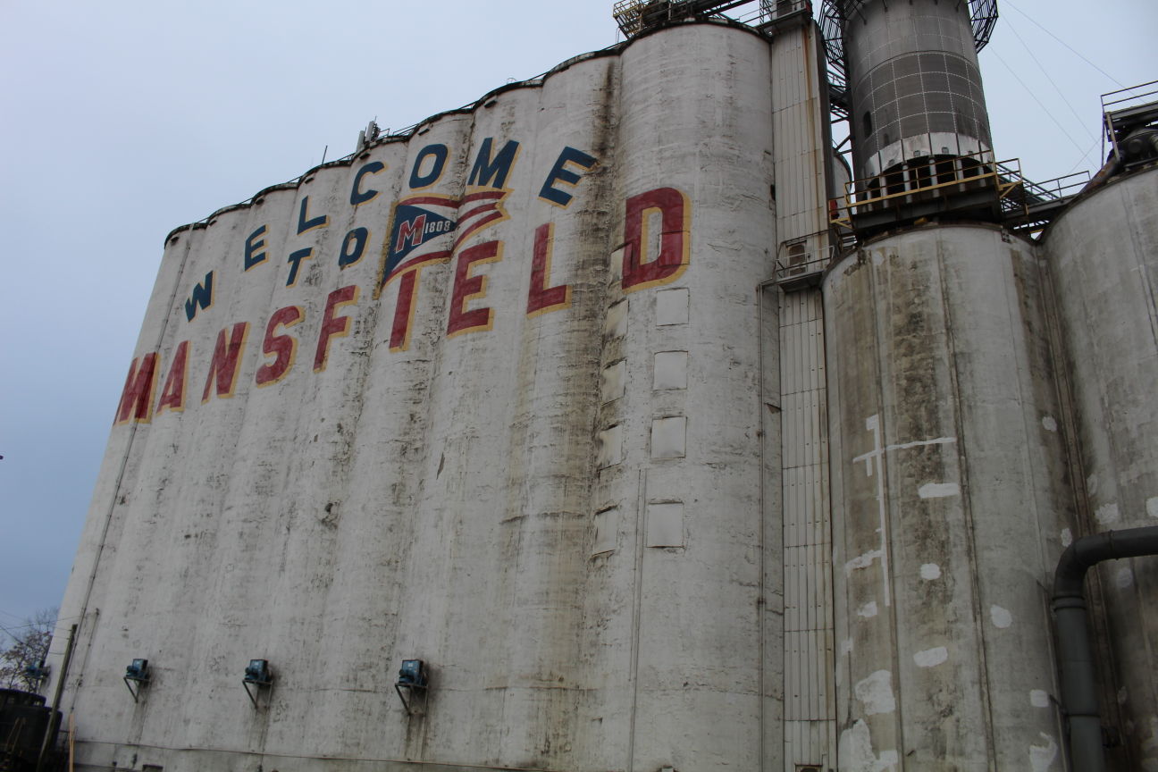 What's the story behind the 'Welcome to Mansfield' sign?