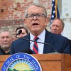 Man in suit speaks at podium