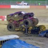 a monster truck jumps a bus