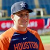 a baseball player talks with members of the media